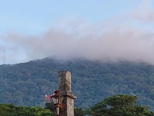 a street light with a mountain in the background at Hostal casa de las gargolas in Amapala