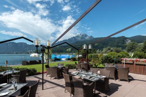 a restaurant with a view of the water and mountains at Seehotel Sternen in Luzern