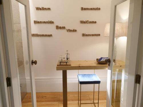 a room with a table and a sign that says different languages at Oportoflag center in Porto