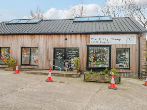 a building with orange cones in front of a store at Swallows Nest in Macclesfield