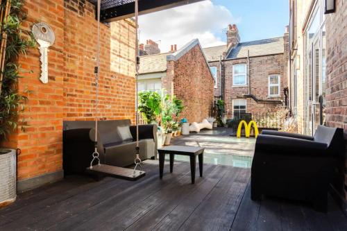 a patio with furniture and a pool in a building at Spectacularly Unique 4 Bedroom House in Bethnal Green in London