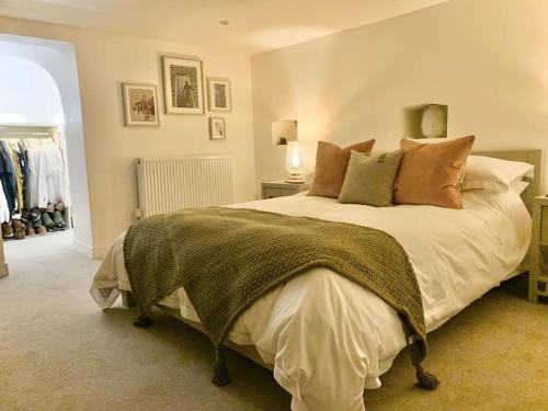 a bedroom with a large bed with pillows at City Apartment, 2 min walk to Norwich centre. in Norwich