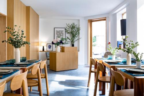 a dining room with wooden tables and chairs at Baba Hotel in Paris