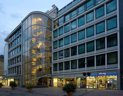 a large glass building with a lot of windows at Mercure Hotel Aachen Am Dom in Aachen
