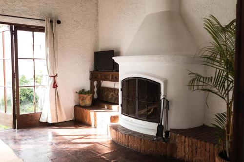 a living room with a fireplace and a window at Cacao Boutique Hotel in Antigua Guatemala