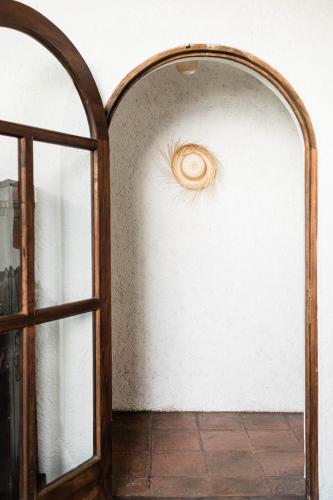 an open door to a room with a mirror at Cacao Boutique Hotel in Antigua Guatemala