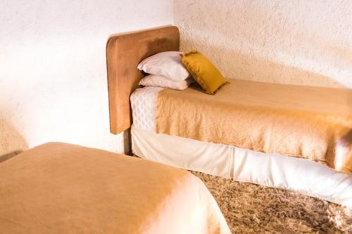a couple of beds in a room at Cacao Boutique Hotel in Antigua Guatemala