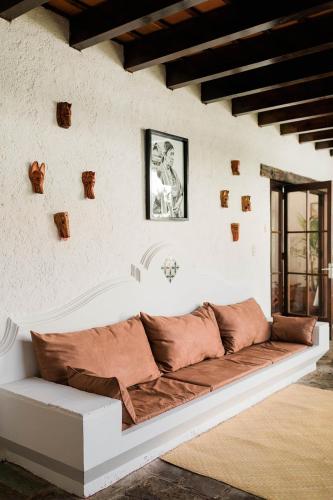 a couch sitting in a room with a wall at Cacao Boutique Hotel in Antigua Guatemala