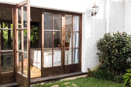 an open sliding glass door to a patio at Cacao Boutique Hotel in Antigua Guatemala