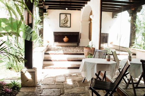 a patio with a table and chairs and a fireplace at Cacao Boutique Hotel in Antigua Guatemala