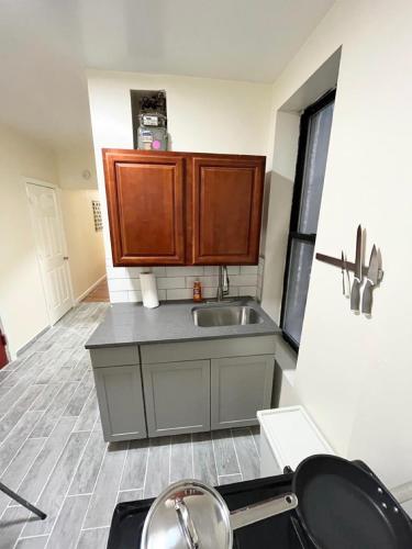 a kitchen with a sink and a counter top at Beautiful private rooms in a shared apartment upper west side in New York