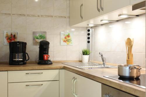 a kitchen with a sink and a coffee maker on a counter at Ferienwohnung Krohn Cuxhaven in Cuxhaven