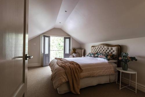 a bedroom with a large bed in a attic at Nest on the Hill - A Luxurious Escape in Red Hill South