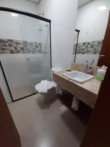 W łazience znajduje się prysznic, toaleta i umywalka. w obiekcie Alpes Flats w mieście Campos do Jordão