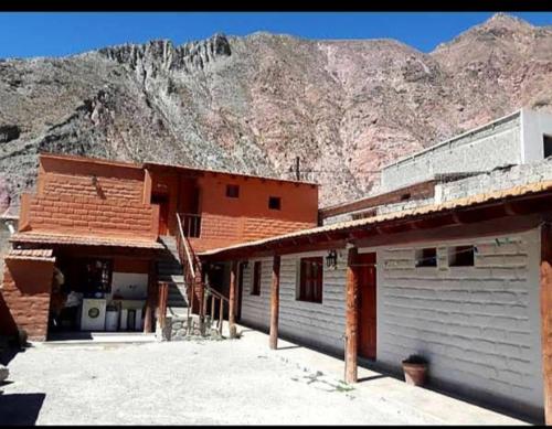 a building with a mountain in the background at El mirador de iruya in Iruya