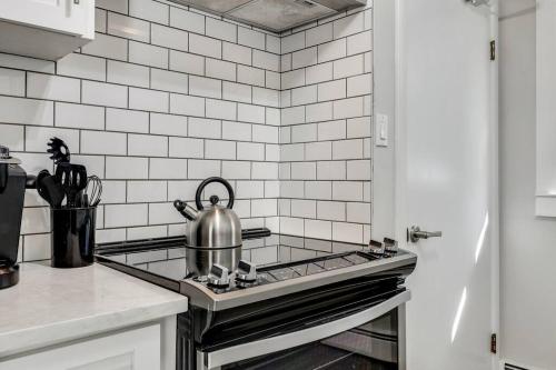 a kitchen with a stove with a tea kettle on it at Roxboro #2 Premium Central 3BR Home Parking, Wifi in Calgary