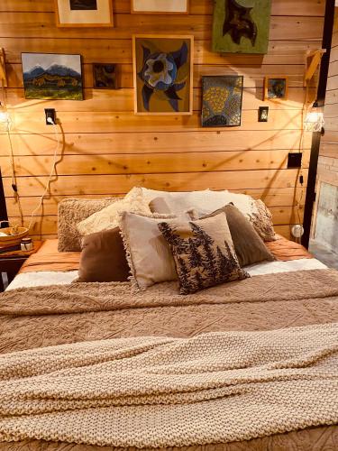 a bed in a room with a wooden wall at The Eagle's Roost in Port Angeles