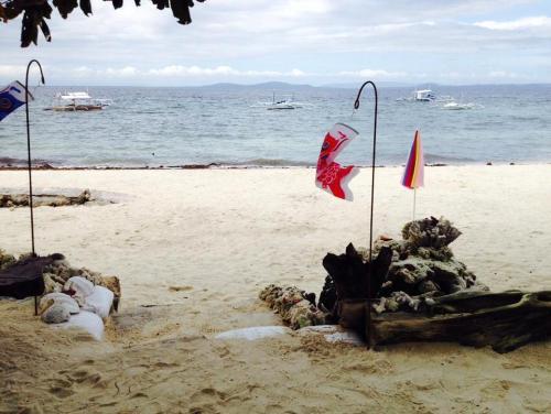 a sand castle on a beach next to the ocean at Liwayway sa Bohol Pamilacan Resort in Baclayon