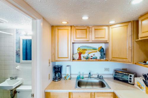 a kitchen with wooden cabinets and a sink at Shorely Suite in Atlantic Beach
