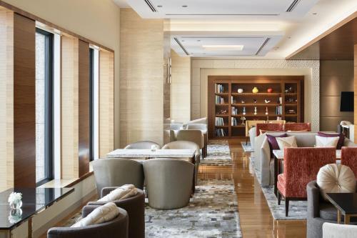 a restaurant with couches and tables and a lobby at InterContinental Hotel Osaka by IHG in Osaka