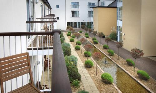 a balcony with a row of plants on a building at The Quay Hotel and Spa in Conwy