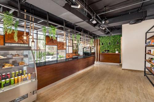 a store interior with a large window and plants at Wyndham Residences The Palm in Dubai