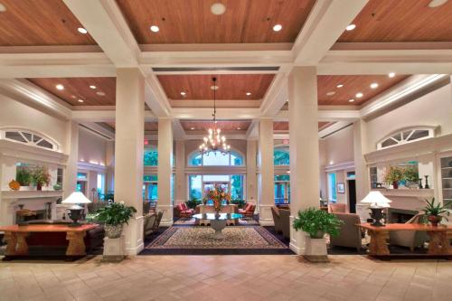 a lobby of a hotel with a chandelier at Cypress Bend Resort, a Wyndham Hotel in Many