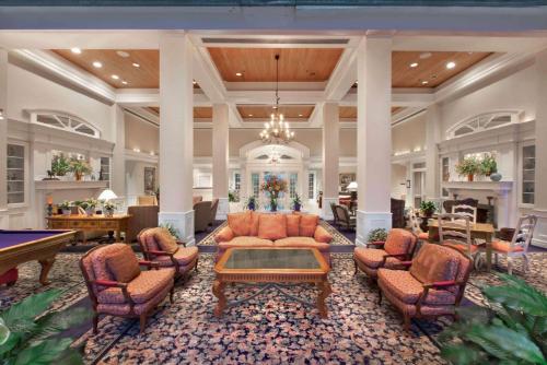 a large living room with a pool table and couches at Cypress Bend Resort, a Wyndham Hotel in Many