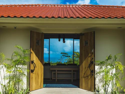 una porta aperta per una casa con vista su un balcone di Kanehide Kise Country Club a Nago