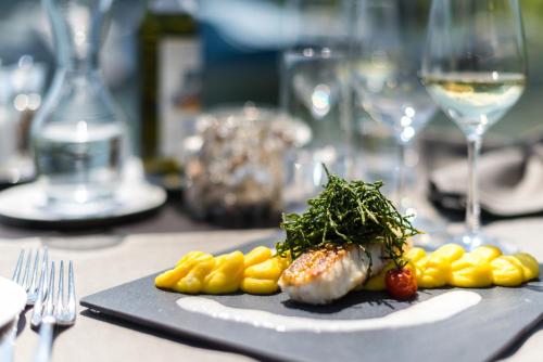 a plate of food on a table with wine glasses at Seehotel Sternen in Luzern