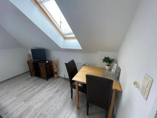 a dining room with a table and chairs and a skylight at Pension Lizzi in Vienna
