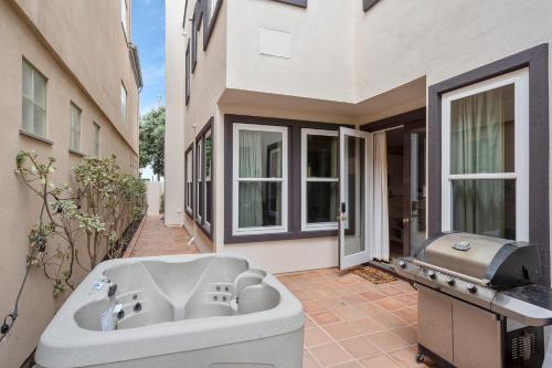 a bath tub sitting outside of a building at The Goldenwest Ocean view home w jacuzzi AC Bikes newly remodeled in Huntington Beach