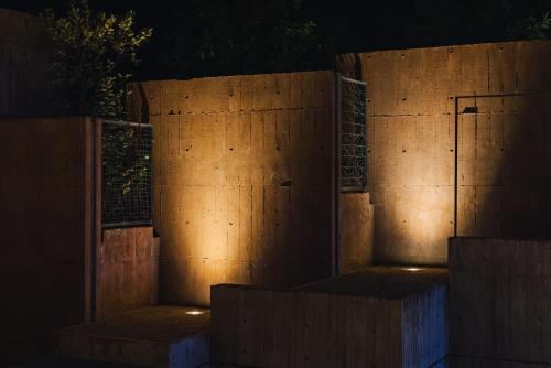 a concrete wall with lights on it at night at SEKIYA RESORT Galleria Midobaru in Beppu