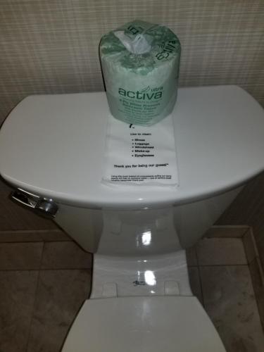 a roll of advice on a toilet in a bathroom at Chelsea Inn in San Francisco