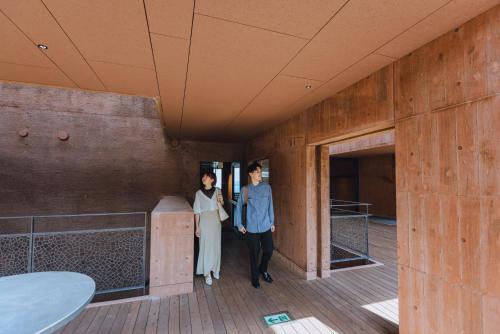 a man and a woman standing in a room at SEKIYA RESORT Galleria Midobaru in Beppu