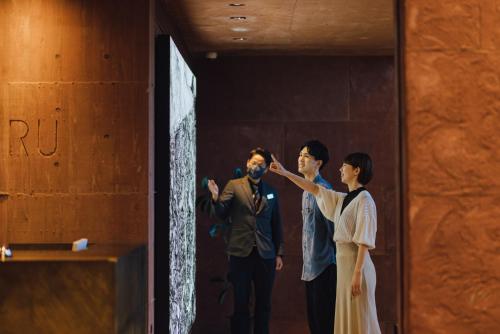 a man and a woman standing in a doorway at SEKIYA RESORT Galleria Midobaru in Beppu