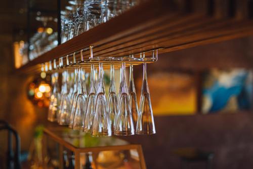 a bunch of wine glasses hanging from a rack at SEKIYA RESORT Galleria Midobaru in Beppu