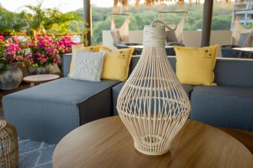 a vase sitting on top of a wooden table at Hotel Casa Bocana in Santa Cruz Huatulco
