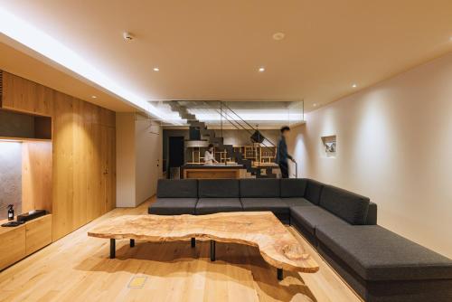 a living room with a couch and a coffee table at SEKIYA RESORT Galleria Midobaru in Beppu