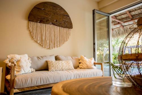 a living room with a couch and a window at Hotel Casa Bocana in Santa Cruz Huatulco