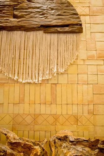 a wall with a bunch ofaments hanging on it at Hotel Casa Bocana in Santa Cruz Huatulco