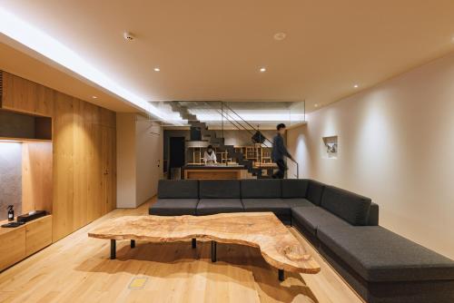 a living room with a couch and a coffee table at SEKIYA RESORT Galleria Midobaru in Beppu
