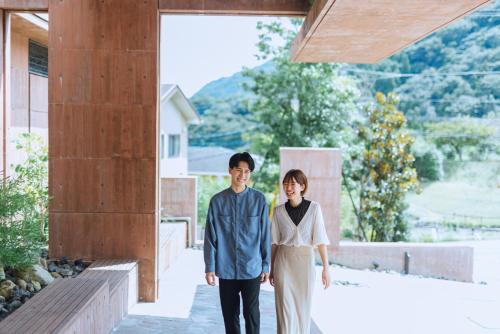 a man and a woman standing outside a building at SEKIYA RESORT Galleria Midobaru in Beppu