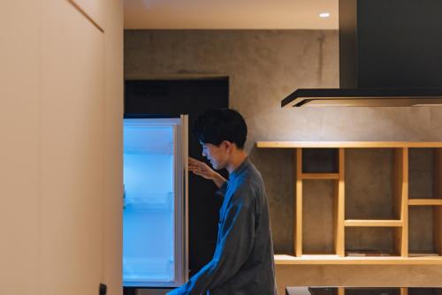 a boy standing in a room looking at a door at SEKIYA RESORT Galleria Midobaru in Beppu