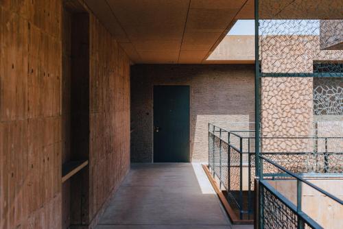 a hallway of a building with a green door at SEKIYA RESORT Galleria Midobaru in Beppu