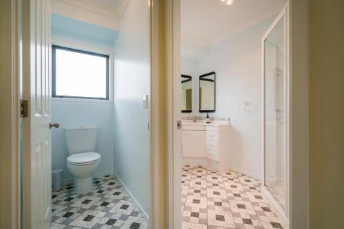 a bathroom with a toilet and a sink at Hosts on the Coast Laze Away on Cook in Cooks Beach