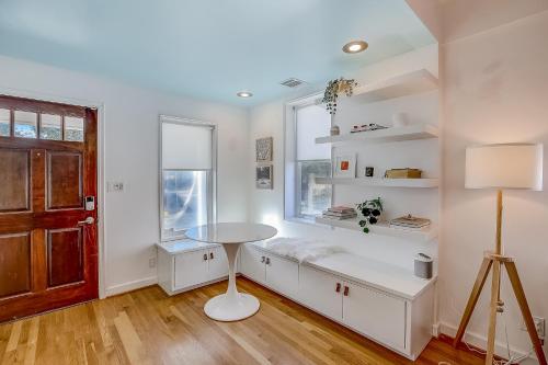 a white room with a table and a window at Earn Your Vacation Stripes in Austin