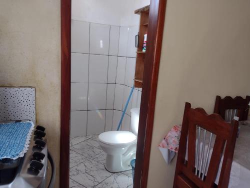 a small bathroom with a toilet and a shower at Sobrado aconchegante in Ilhéus