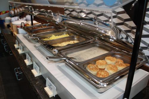 a buffet line with trays of food on display at Holiday Inn Express & Suites Morton Peoria Area by IHG in Morton