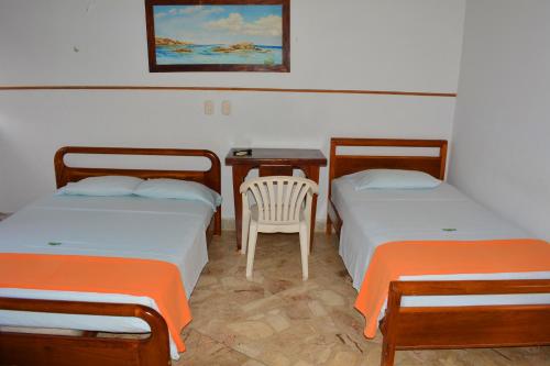 Postel nebo postele na pokoji v ubytování Hotel Tayrona